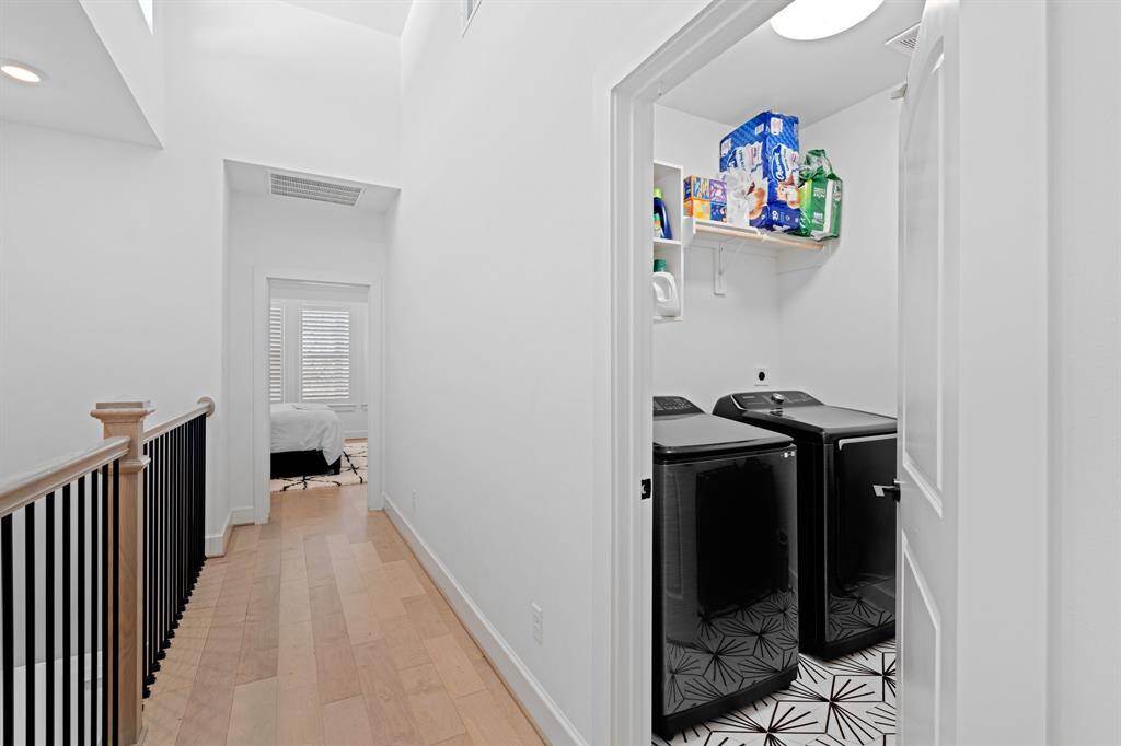 Down the hall from the primary, you will find a secondary bedroom with its own ensuite bath, along with the in house utility room.