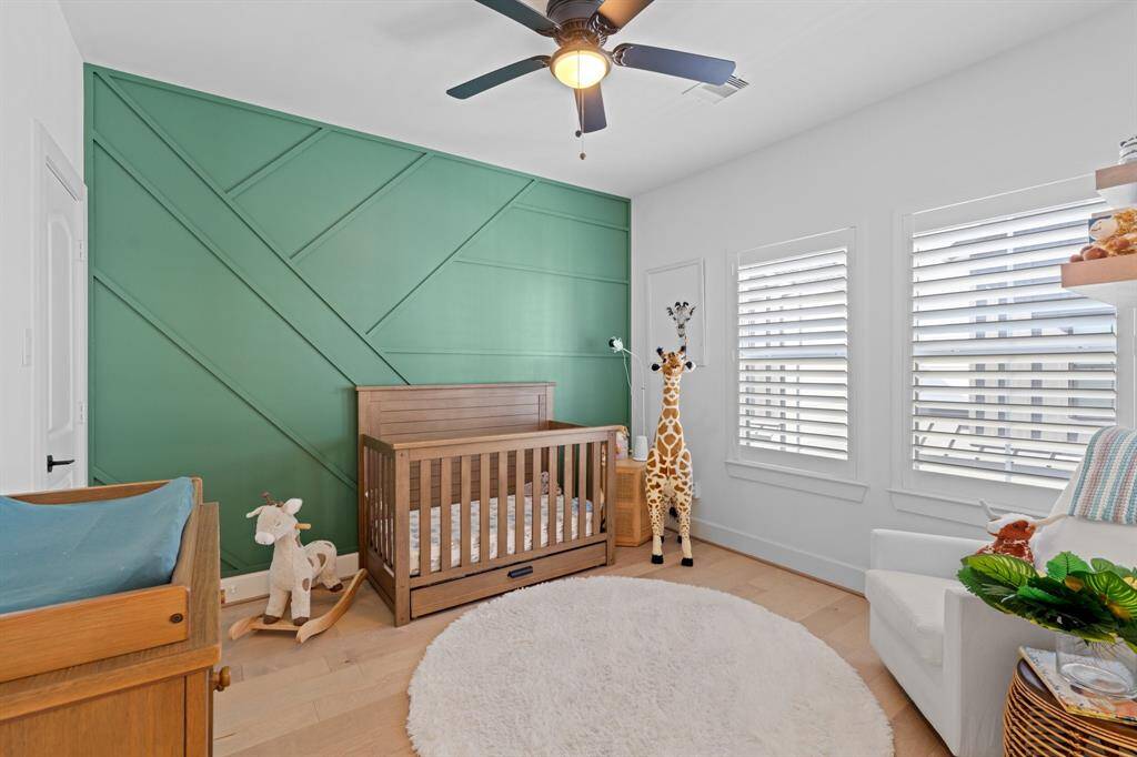 This secondary bedroom features an accent wall, spacious closet, and an ensuite bathroom.