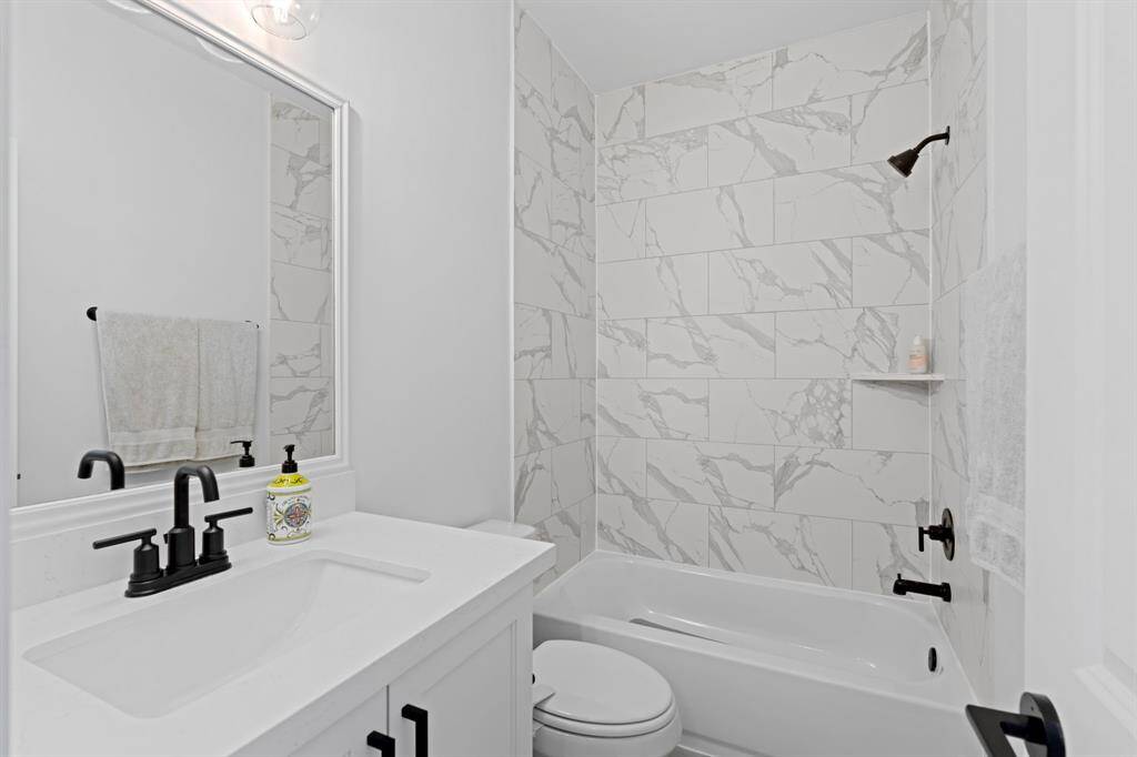 The secondary ensuite bathroom features a tub/shower combo.