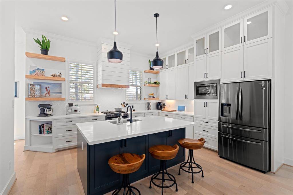 On the second floor, you'll find the open concept kitchen, dining, and living spaces, featuring a chef-inspired kitchen with a large oversized island with bar seating.