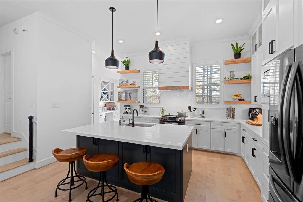 Towards the back of the kitchen, you'll find a bar area leading out to the second floor balcony.