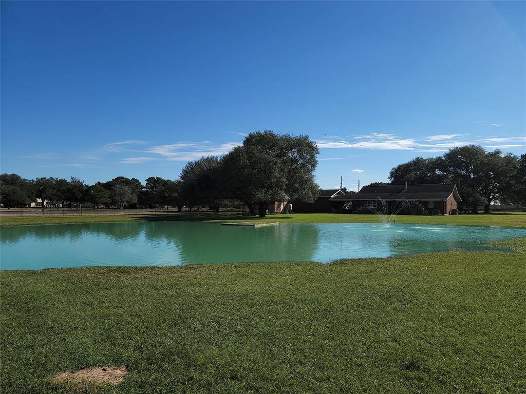Full view of the stocked pond with a pier.