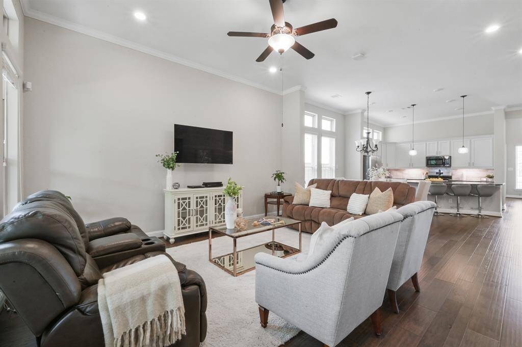 There is room for tons of seating in your living area already equipped with a ceiling fan.