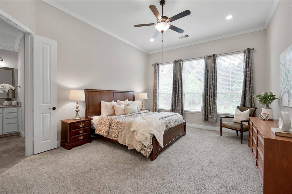 Your Primary Bedroom is HUGE with high ceilings, recessed lighting & a ceiling fan. There are also nice double doors leading out to your Primary Suite.