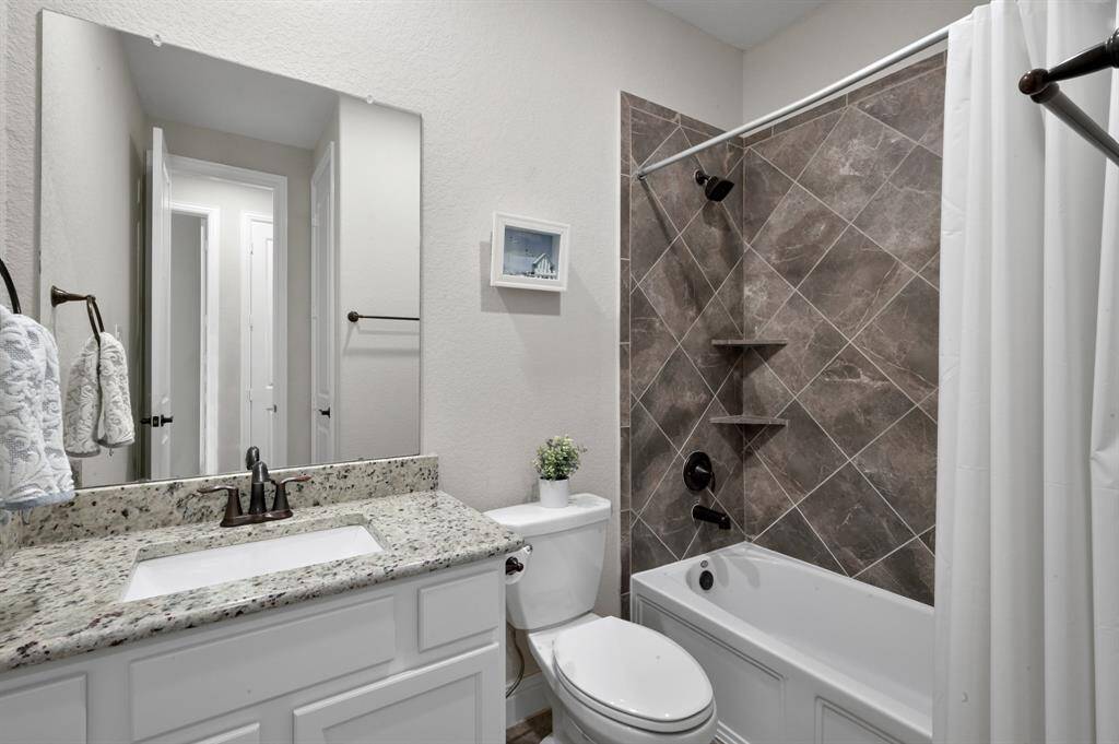 The secondary bathroom is conveniently located in between the second and third bedroom. It has a shower and tub combo with a nice modern vanity.