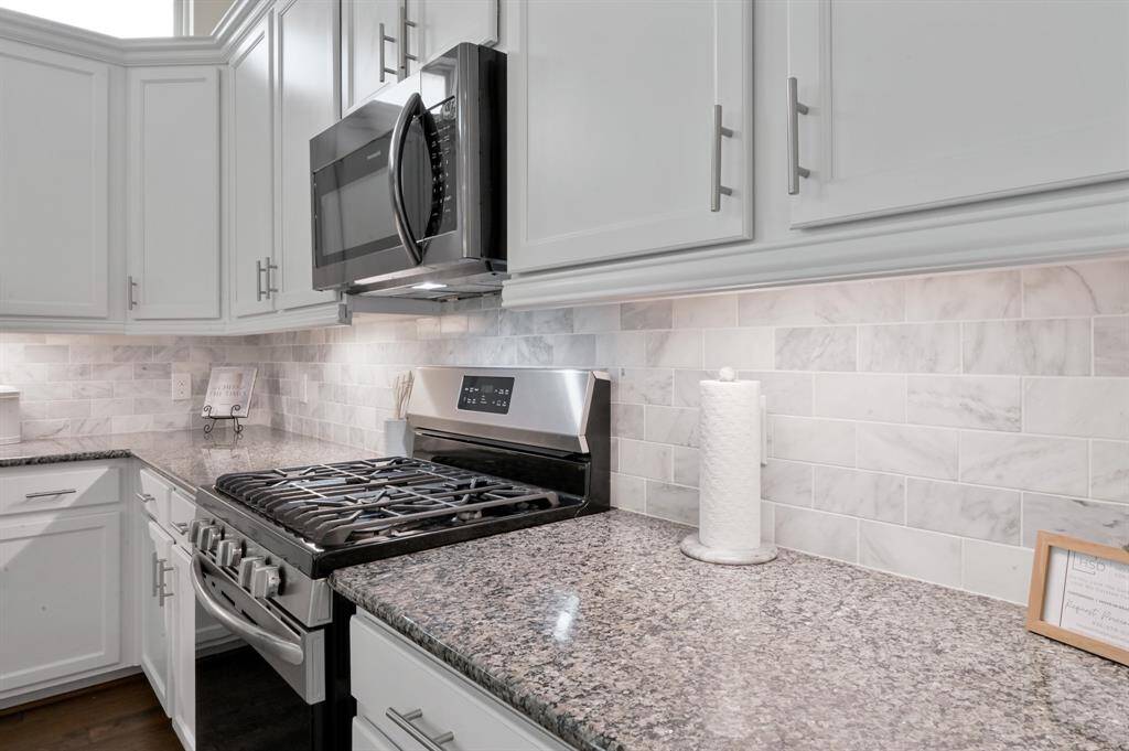 Gas stove & Under Cabinet lighting in your modern kitchen with marble subway tile backsplash