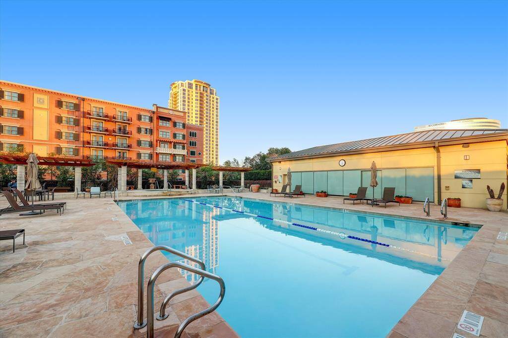 The glistening waters of the swimming pool with cabana like shaded seating area.