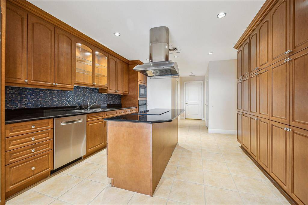 A dream kitchen! Featuring GE Monogram, appliances, double stainless steel sinks, a large walk-in pantry, floor to ceiling cabinetry provides ample storage and under counter lighting. The island's breakfast bar is excellent for having meals or conversations!