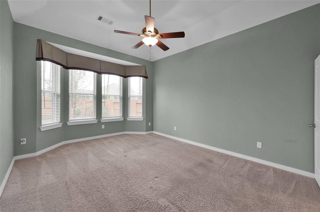 Spacious primary suite with a cozy bay window area.