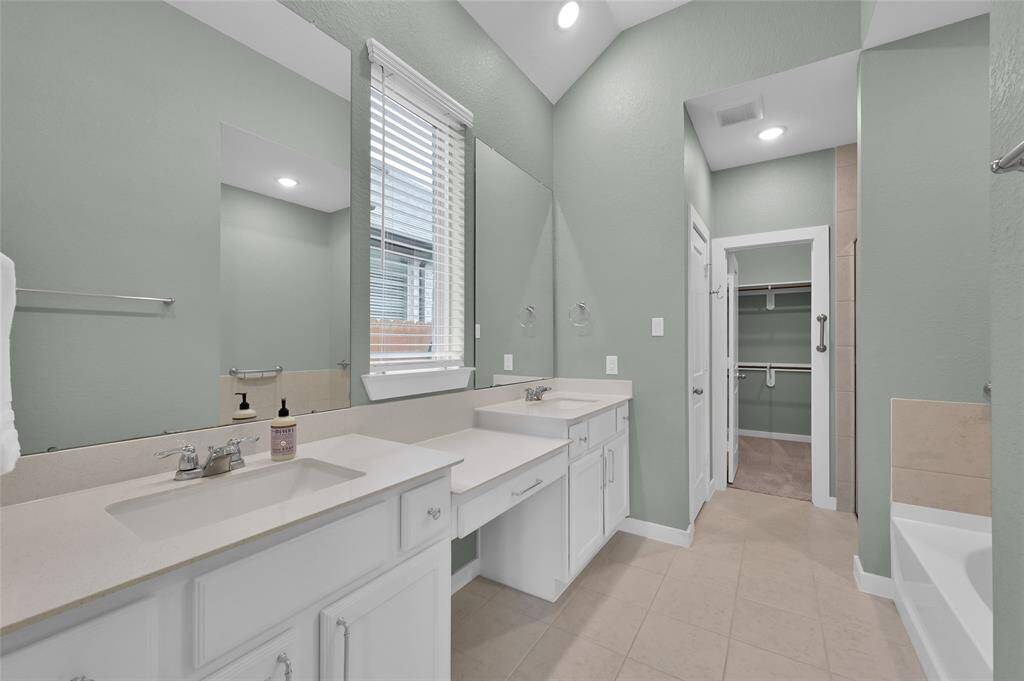 Primary bath features a separate sinks and vanity section.