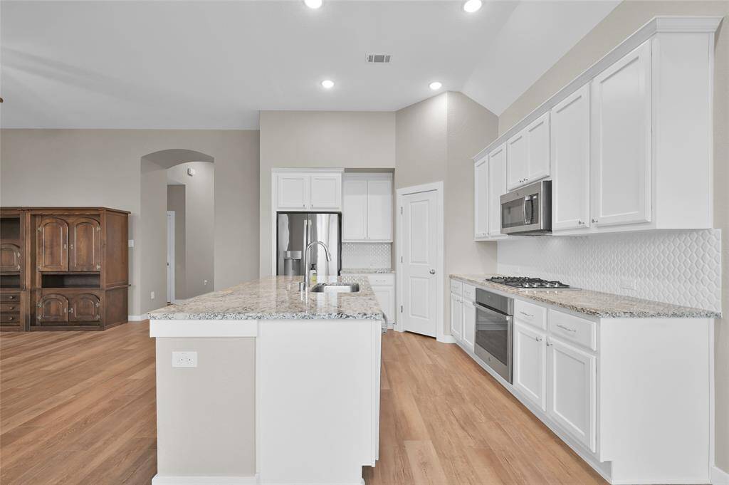 Modern kitchen with granite countertops.