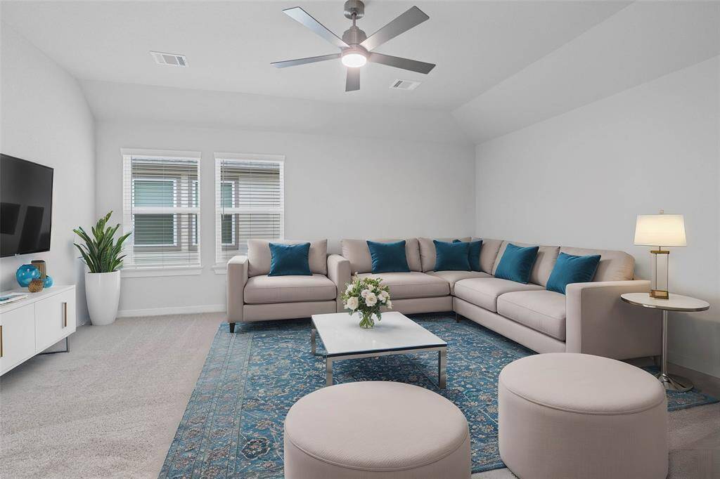 This spacious and bright game room features custom paint, ceiling fan, gorgeous plush carpet, and large windows with privacy blinds! With the ample amount of space provided, you can turn this area into anything! From a media room to a children's play room, the possibilities are endless!