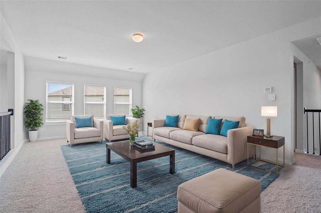 Come upstairs to this spacious and bright game room featuring custom paint with gorgeous plush carpet, and large windows w/privacy blinds! With the ample amount of space provided, you can turn this area into anything!