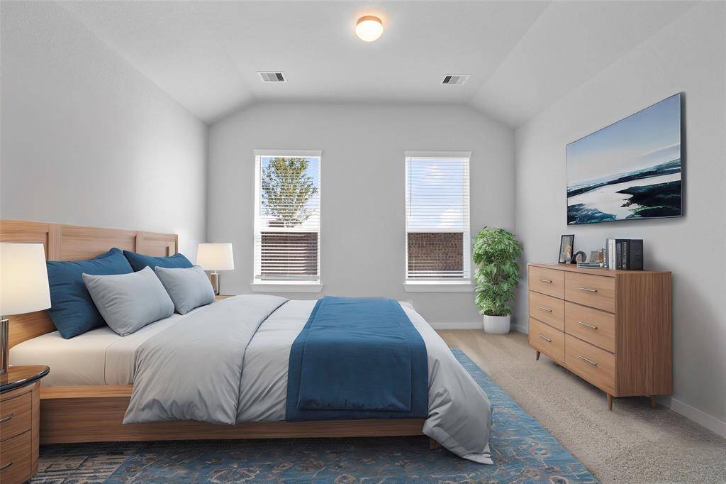 Come and unwind after a long day in this magnificent primary suite! This spacious room features plush carpet, warm paint, high ceilings, and large windows with privacy blinds!