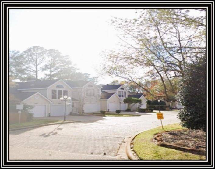 Charming suburban neighborhood with well-maintained homes, featuring spacious driveways and manicured lawns. The area is peaceful with mature trees providing shade and a welcoming atmosphere.