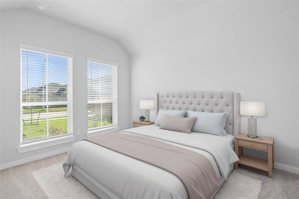 This secondary bedroom features high ceilings, lighting, custom paint, plush carpet, and a large window with privacy blinds!