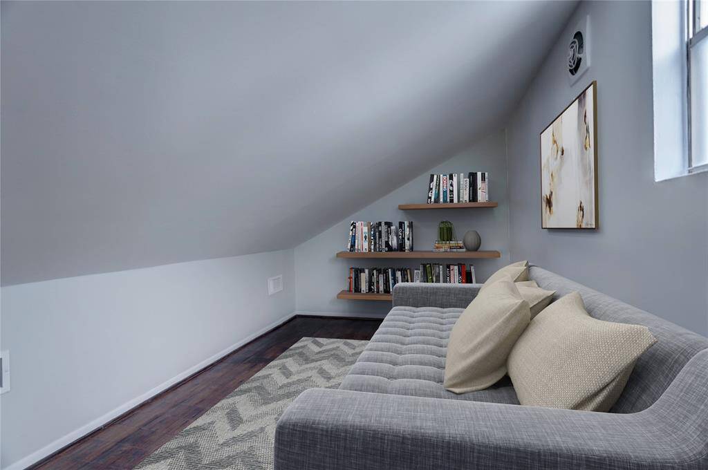 Ascending the winding stairwell, one finds the third-floor flex room that provides additional room for movie marathons or peaceful leisure time with a good book. Digitally Staged.
