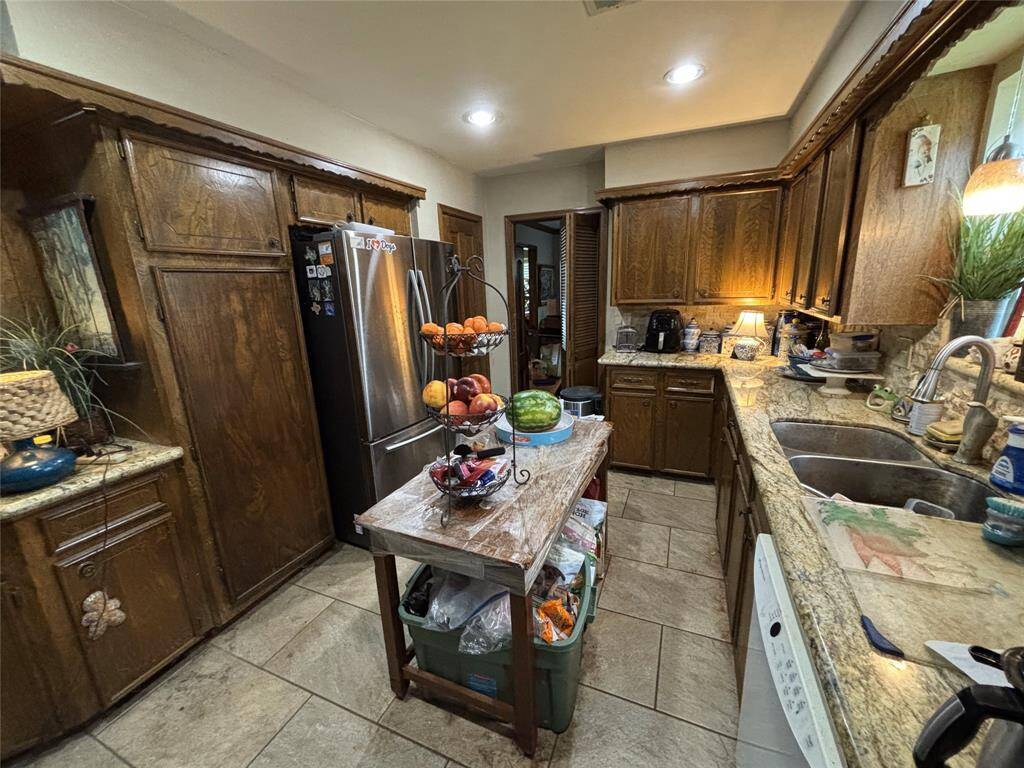 Recessed lighting with granted countertops.