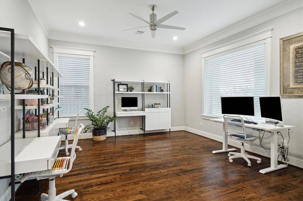 The spacious study is located off the front of the home and offers amazing natural light, recessed lighting, designer ceiling fan, hardwood floors, and crown molding.