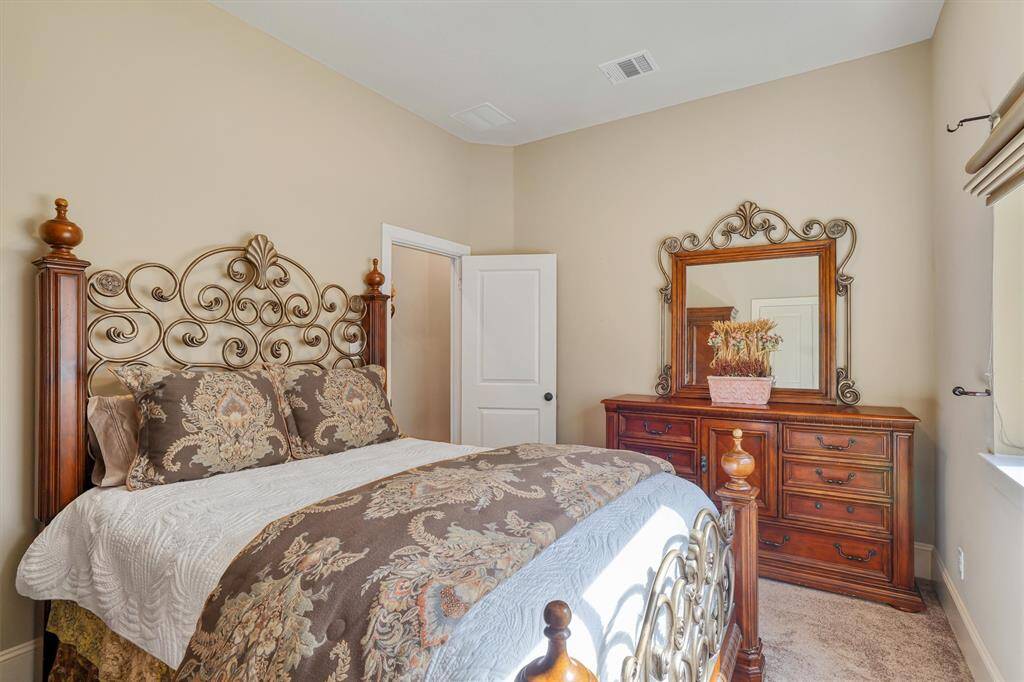 The third full bathroom offers astylish and functional design witha tiled tub/shower combination, asleek vanity with ample counterspace, and rich wood cabinetryfor additional storage.