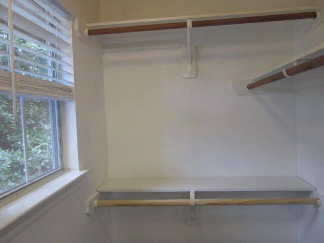 Walk-in closet with the window and shelving