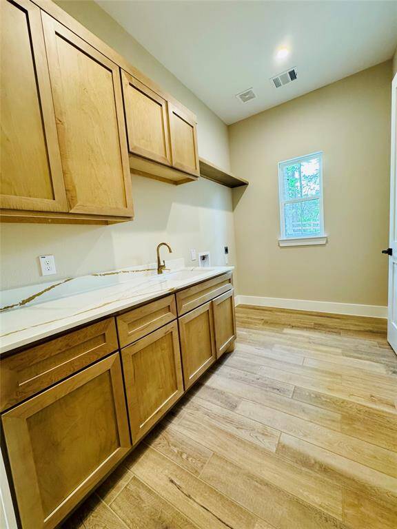 Laundry room connects to hers closet for easy access.