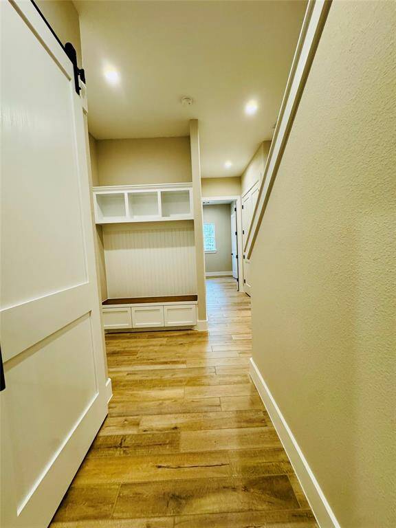 Entrance from the garage with built ins for the kiddos to drop off all their essentials