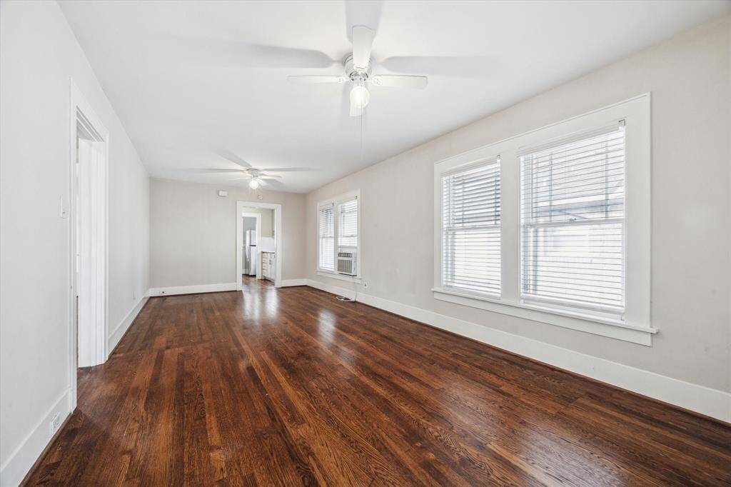 Large living and dining room combo with neutral paint, ceiling fans and upgraded window treatments. Wonderful hardwood floors throughout the unit.