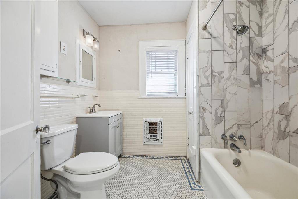 Bathroom has a recent vanity and tile work.