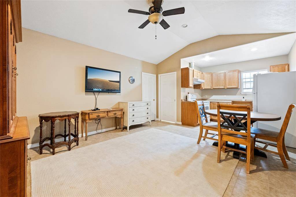 Bright, open-concept guest suite living area combining a cozy dining space and kitchen. Features a welcoming atmosphere for entertaining or relaxing.