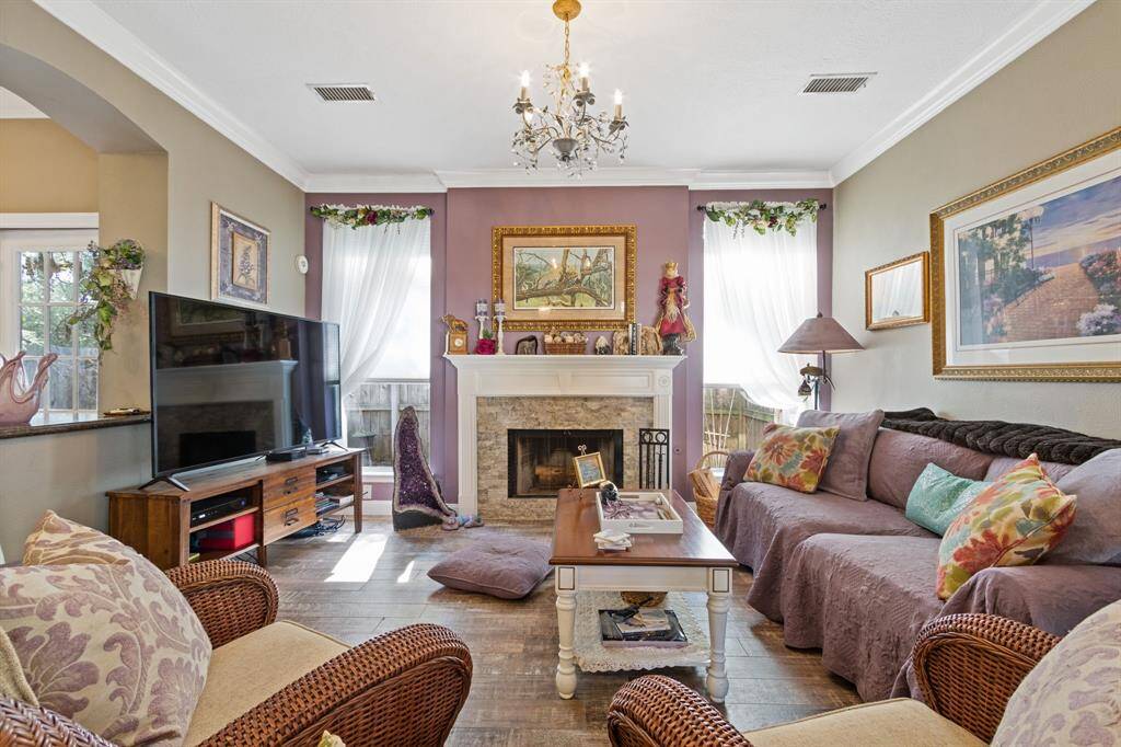 An updated stone gas fireplace is the centerpiece of the living room.