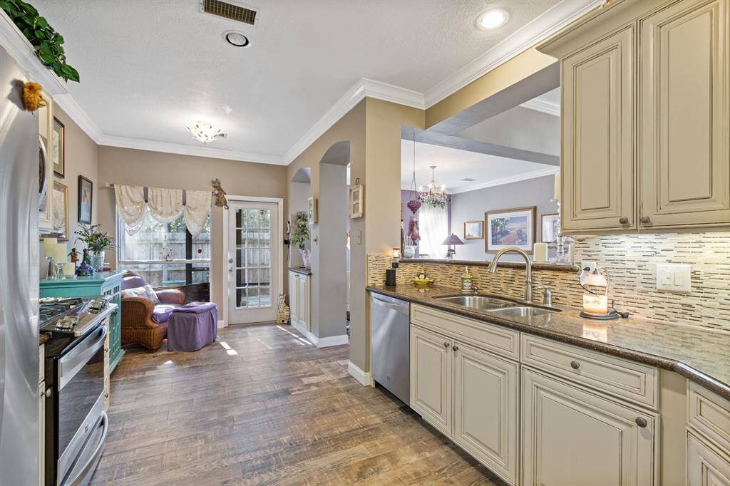 A view across the kitchen into the breakfast space. Pleae note the dual basin undermount sink and modern fixture as well.