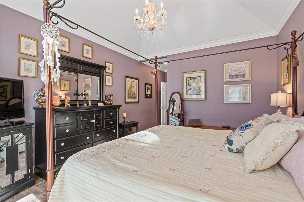 The generous room can accommodate most furniture sets. Note how the crown molding and chandelier enhance the luxurious feel of the room.