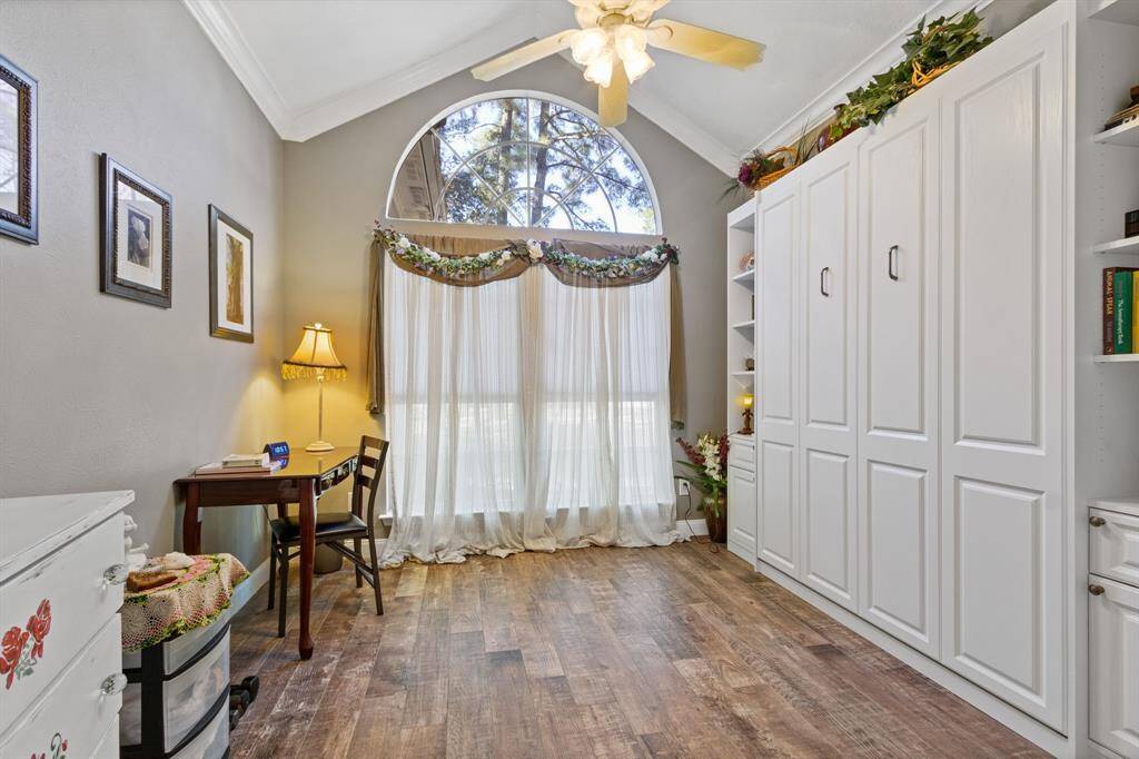 The front secondary bedroom offers a lot of versatility.  A pull down Murphy bed is an easy set up for overnight guests but can be tucked away so the room can be utilized for other purposes when guests are not in town.