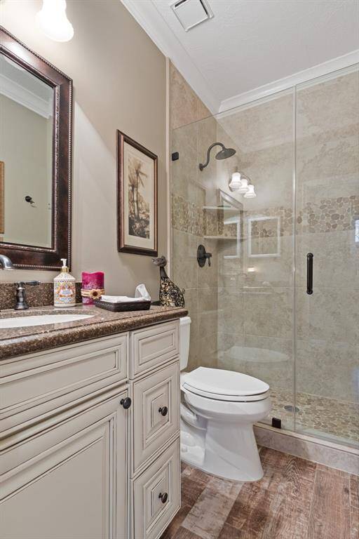 The striking secondary full bath offers an updated vanity, granite counters, undermount sink, and an awesome walk-in shower!