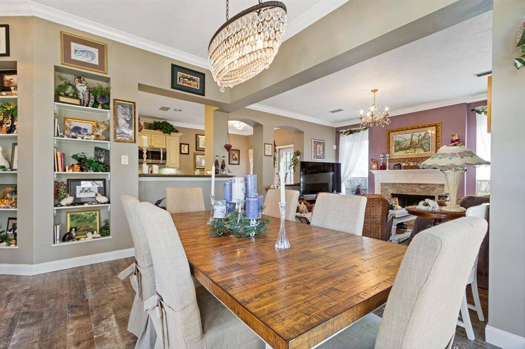 Extensive crown molding was also added throughout the home as part of the updating process.  The formal dining space is adjacent to the living room making the open space ideal for entertaining.  The opening into the kitchen offers a convenient serving counter for the dining room as well.
