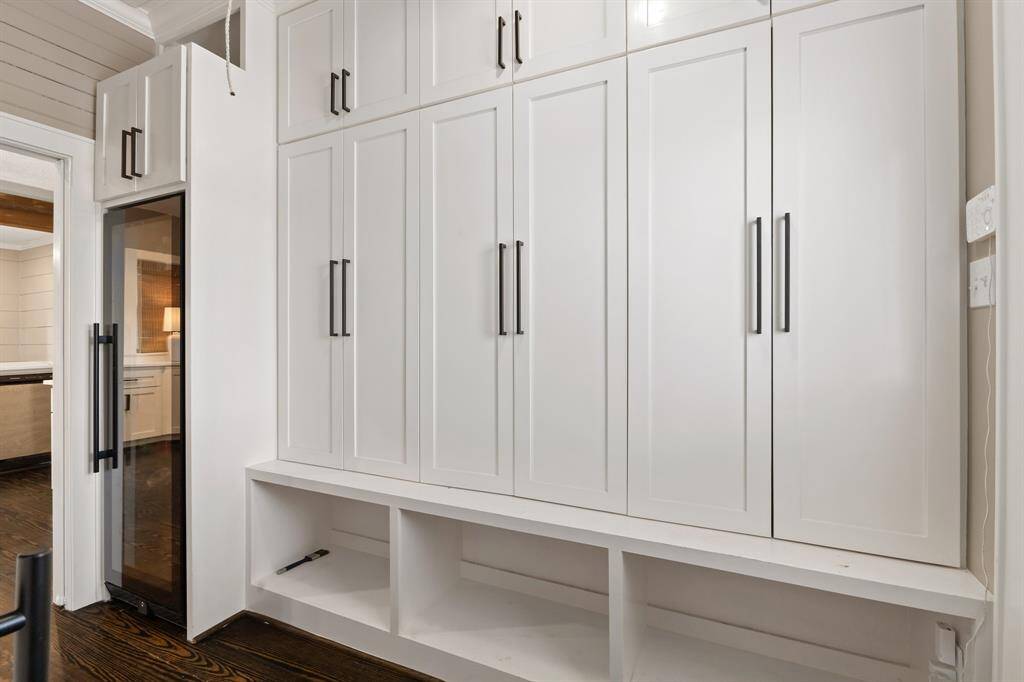 Back door entry way features custom cabinetry that can be used as lockers or coat hangers and a place to put your shoes.
