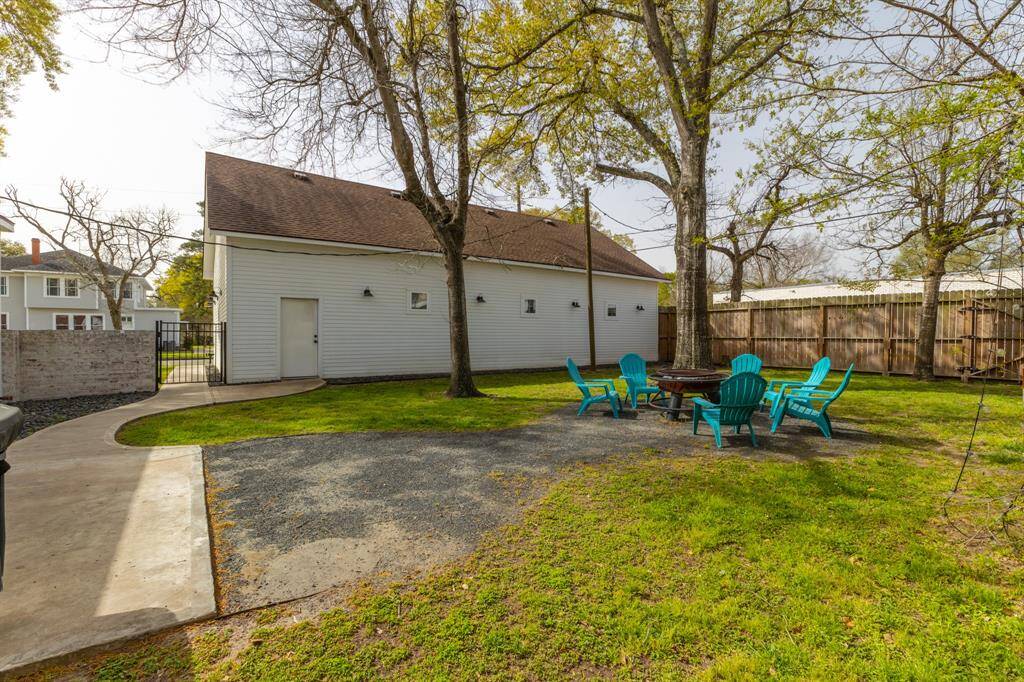 Backyard - features 8 ft tall privacy fence and the shop has lighting zones for illuminating the backyard and driveway. To the left (not pictured) is the whole-home generator that automatically turns on when there is a power outage.