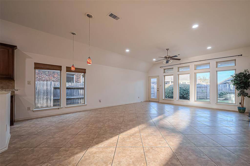 Large family room with a wall of windows providing lots of natural light