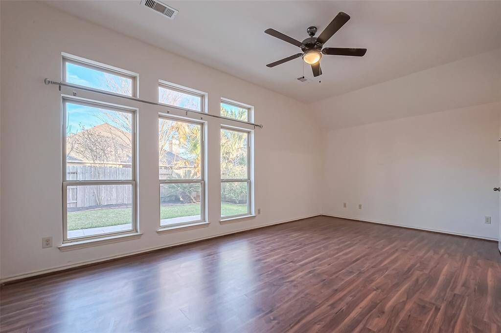 Primary bedroom with large windows for lot of natural lighting