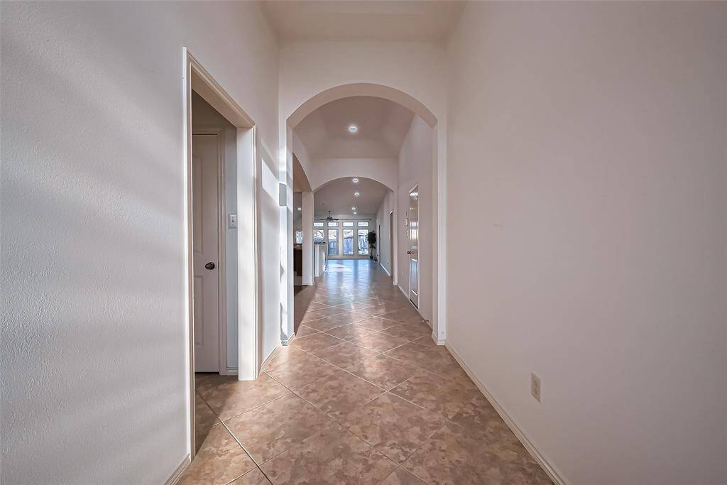 Extended entry way! Elegant tile flooring extends through the main living areas, complemented by wood flooring in the formal dining room and luxury vinyl plank in the bedrooms.