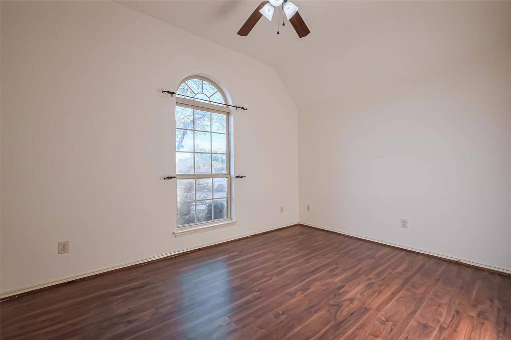 Secondary bedroom sits at the front of the home and can be used for a home office or workout space.