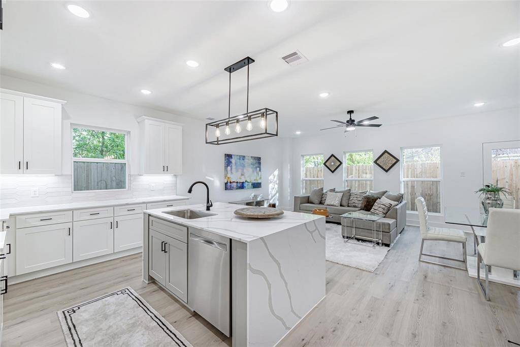 You are welcomed by a modern entryway with sleek, frosted glass entry doors and light oak floors. The open floor plan leads to a bright, inviting living area with lots of windows, well-chosen furniture, goes well with muted accents.