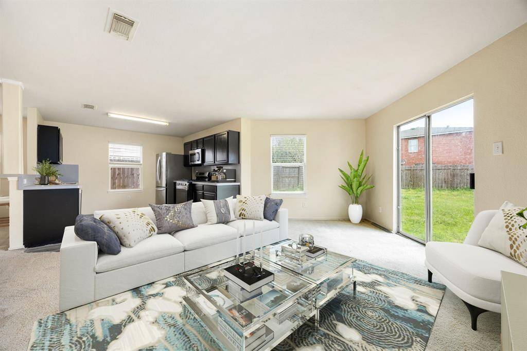 This family room is more like a GREAT room featuring custom paint, high ceilings, and a sliding door providing a lovely view of your backyard to keep an eye out on the kids or pets playing. *Virtually Staged