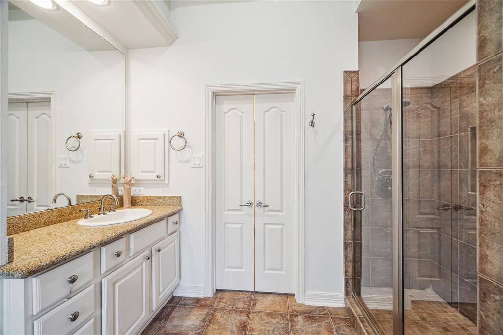 Walk in shower and 2 large closets with custom drawers