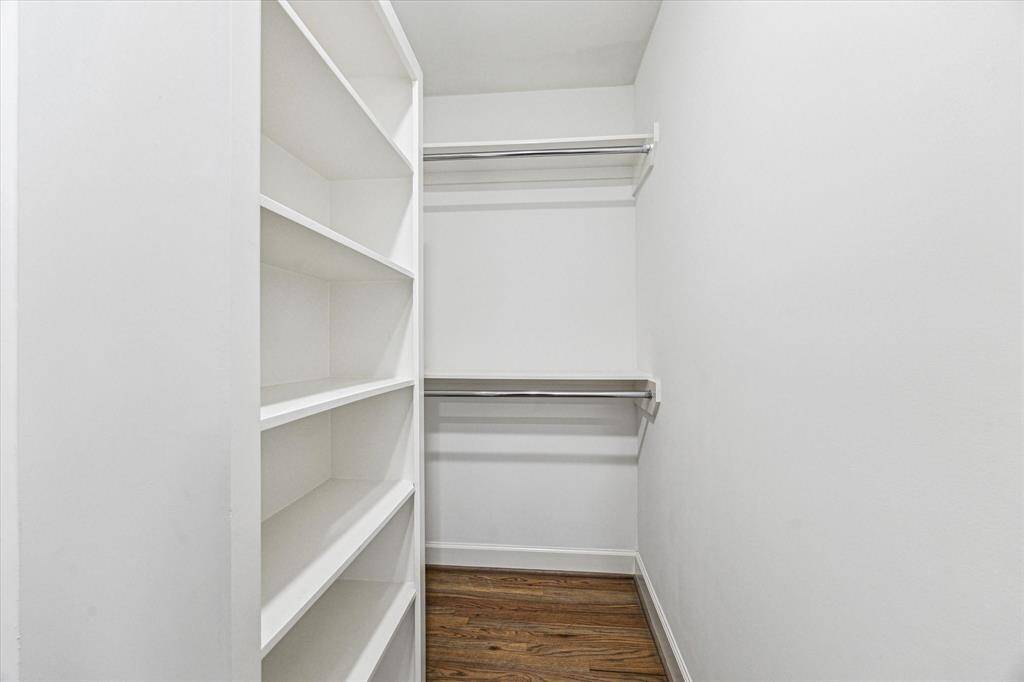 This spacious walk-in closet provides ample room for hanging clothes, while built-in shelves offer convenient storage for shoes, bags, and accessories. In addition to this large closet is a separate custom wardrobe, adding even more storage and organization to this well-designed owner's retreat.