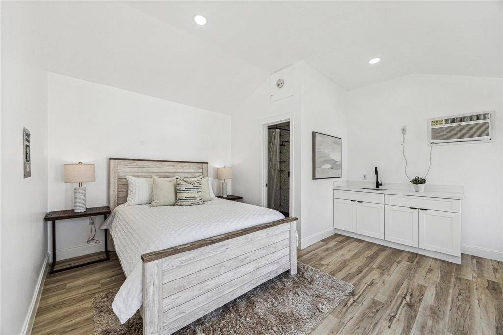 Inside, luxury vinyl plank flooring flows seamlessly throughout. Soft neutral paint, stylish cabinetry, and a raised ceiling make this versatile retreat feel open and airy.