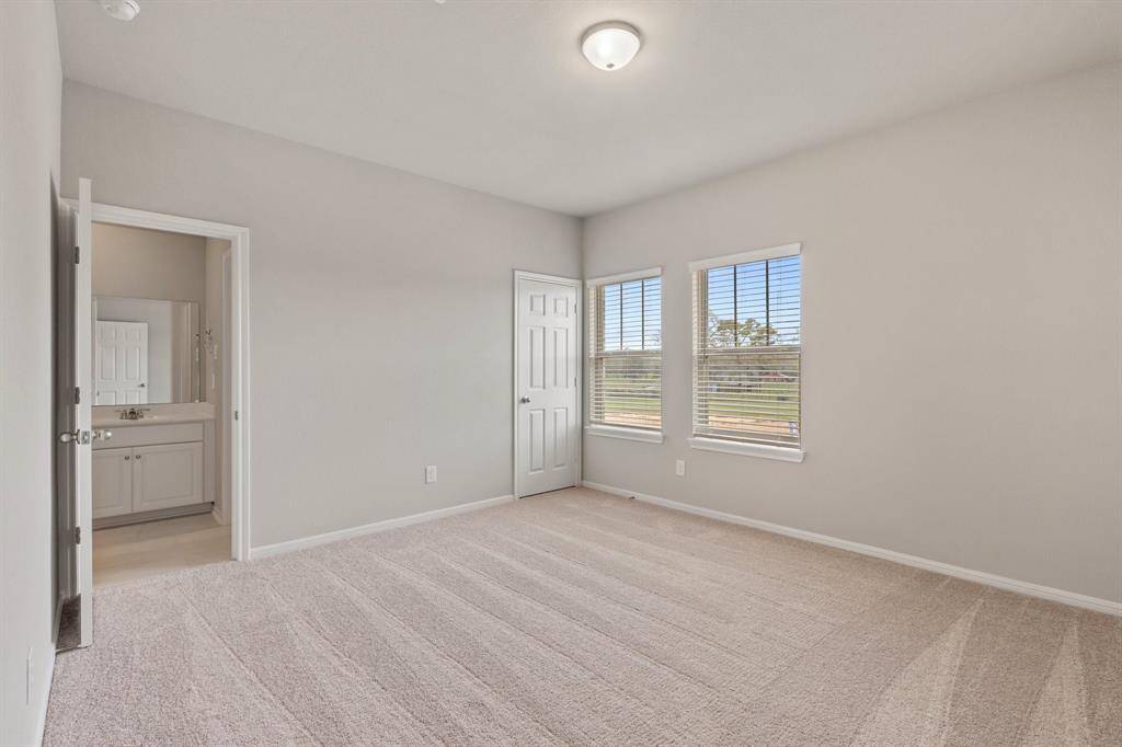 Your secondary bedroom features plush carpet, fresh paint, closet, and a large window that lets in plenty of natural lighting.