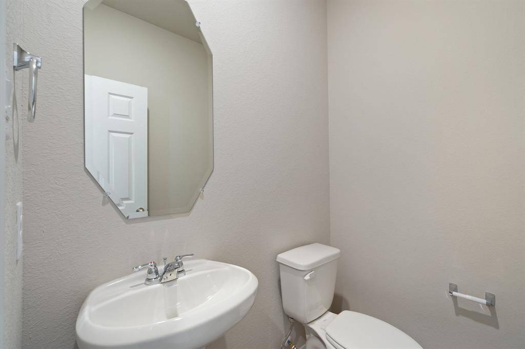 This charming home features a beautifully appointed half bath adjacent to the family room, perfect for welcoming guests and adding convenience to your daily life.