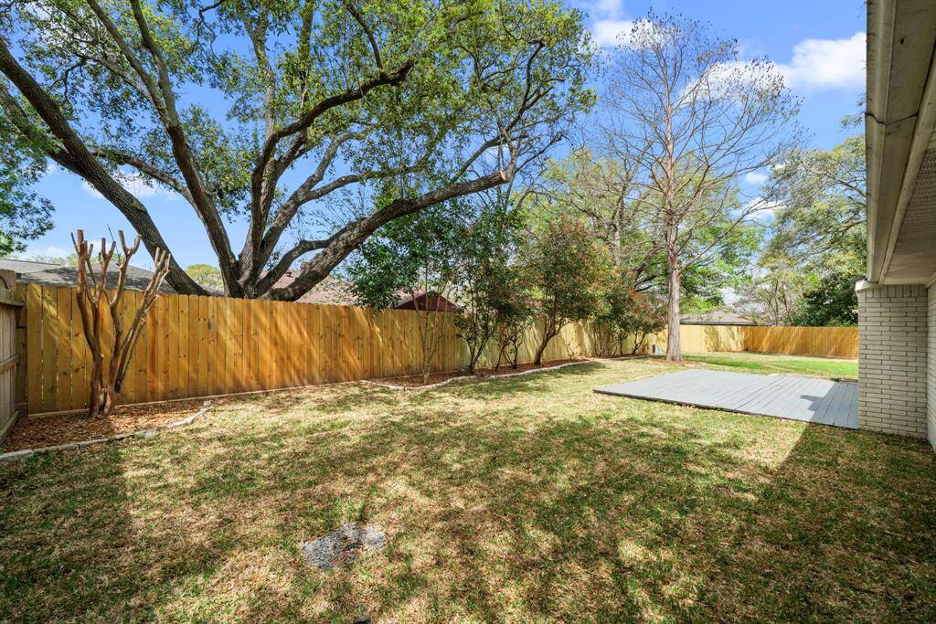 Backyard restored with sod, mulch, and rock pathway